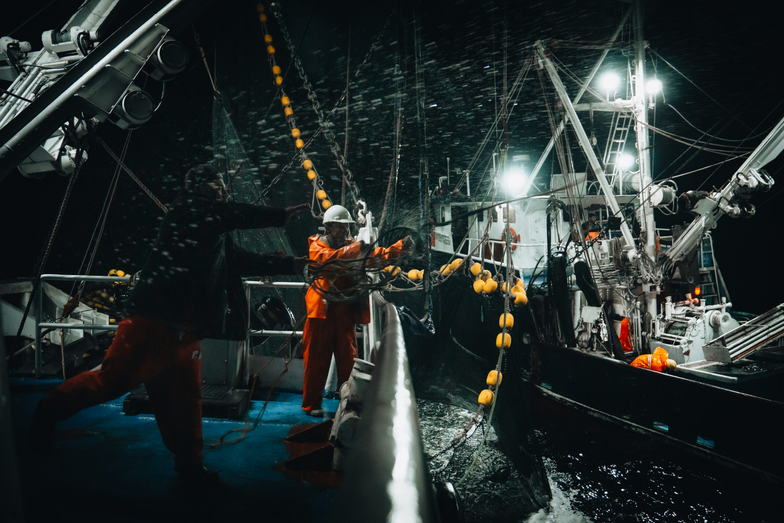 Baja Aqua Farms crew hauling nets during a nighttime offshore operation.